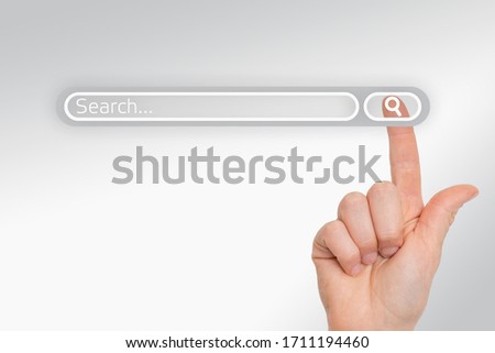Finger is pressing a search button - searching browsing data internet