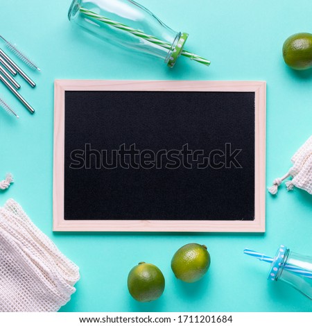 Zero waste border with cotton bags, glass jars, metal straws reusable, fruits on blue table top, copy space. Zero waste lifestyle or sustainable lifestyle concept
