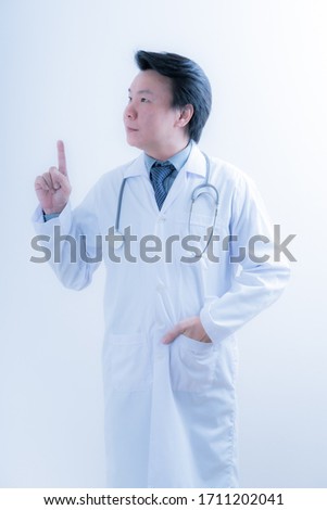 Healthcare and medical concept - young male doctor with stethoscope. Asian male model