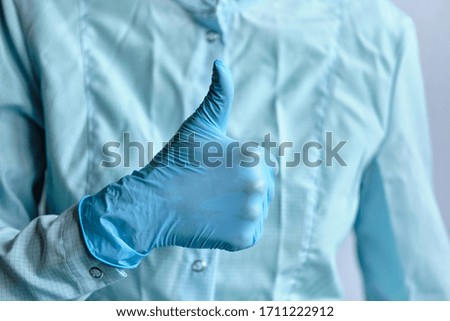 Concept of medical advice from a doctor on protection against the virus with a thumb up.. Close up.