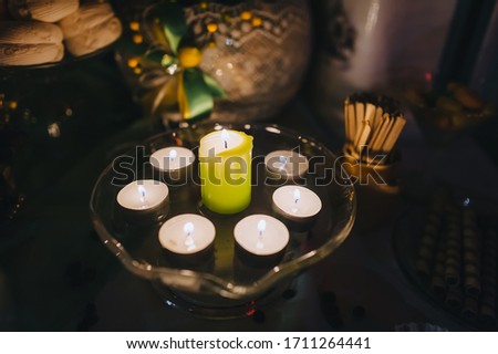 Burning candles close-up in a glass vase in a romantic setting. Photography, concept.