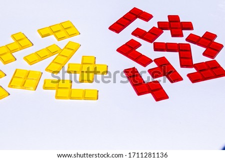 Groups of red and yellow square blocks on white background, high contrast transparent tiles, symbol of taking sites and creating conflict groups of objects that are basically the same, copy space