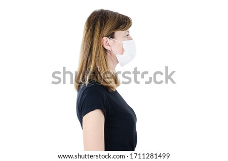 Side view of beautiful woman wearing medical face mask because of air, isolated on white background, copy space. Woman social distancing from corona virus covid-19. Studio shot, 