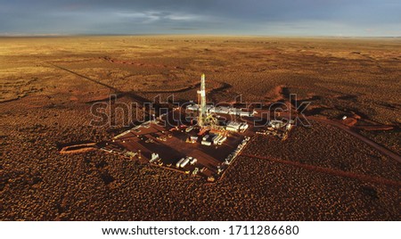 Aerial photo of hydraulic fracturing equipment at sunset. (FRACKING) Royalty-Free Stock Photo #1711286680