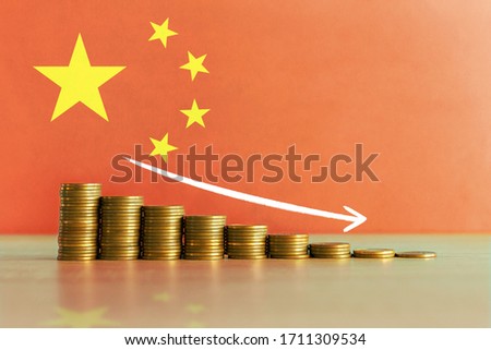 Stock photo of economic crisis and recession concept in China with descending ladder of coins and flag in background