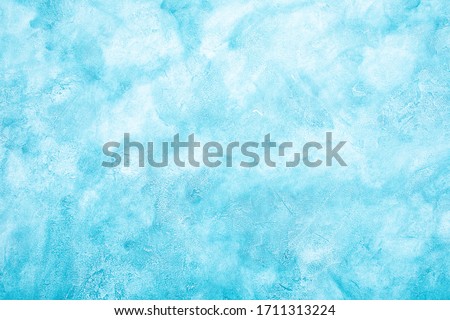 Light blue worn marble or cracked concrete background (as an abstract fairylike background or marble or concrete texture)