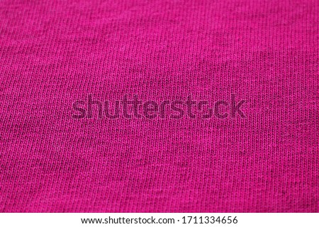 Smooth purple empty fabric texture. Seamless colorful clothes detailed background image. Unprinted plain surface design, blank rose purple cloth close up top view with copy space