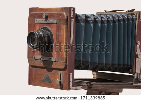 Antique old photo camera isolated on light background.
