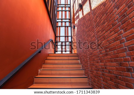 Modern stair steps and cement walls in orange tones
