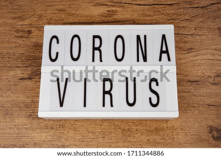 Corona Virus on a Lightbox over wooden Background
