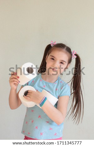 Funny young girl with toilet paper doing quarantine toilet paper stock photo joke
