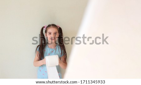 Funny young girl with toilet paper doing quarantine toilet paper stock photo joke