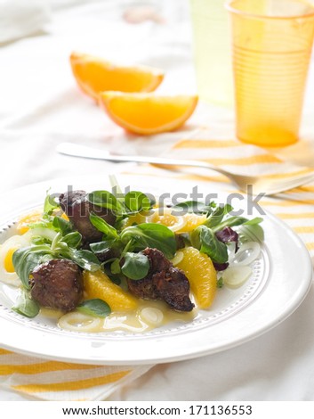 Salad with chicken liver and orange, selective focus