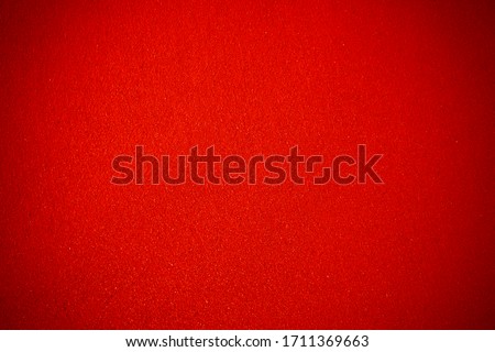 Red structured background with vignetting, darkening at the edges of the photo