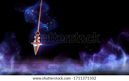 Esoteric And Hypnosis Concept - Pendulum Swinging With Magic Smoke
 Royalty-Free Stock Photo #1711371502