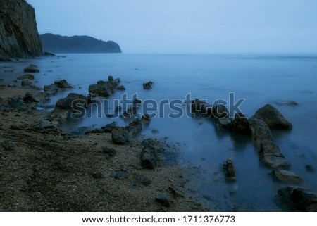 seascape with stones in the sea on a gray day