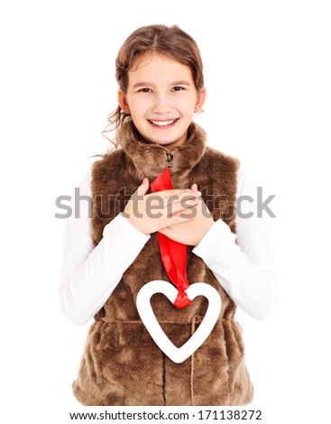 A picture of a young girl holding a heart over white background