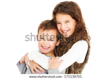 A picture of young siblings hugging over white background