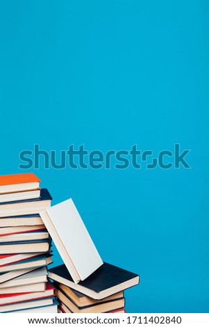 a lot of stacks of educational books in the college library on a blue background
