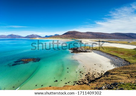 The beautiful sandy beach and clear turquoise sea at Seilebost on the isle of Harris in the Western isles of Scotland Royalty-Free Stock Photo #1711409302