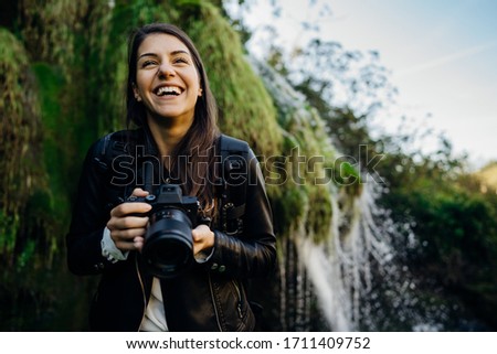 Woman tourist hiker visiting a mountain national park trail.Adventure tourist landscape photographer exploring nature.Nature and environment lover.Healthy lifestyle,enjoying outdoor active vacation