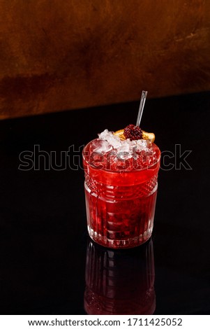Raspberry mojito with dried mandarin artistic beverage presentation in black background. Mexican beverage in casual dine in restaurant picture for book menu concept.
