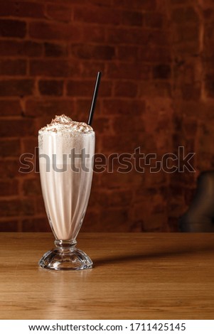 Milkshake horchata in a fine presentable glassware bricks background photography. Beverage picture best use for promotion or book menu concept.