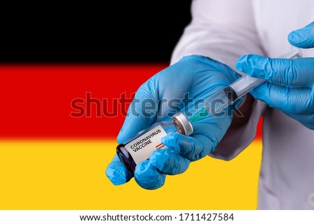 Vaccine and syringe injection. It use for prevention, immunization and treatment from corona virus infection (novel coronavirus disease 2019, Covid-19). Germany Flag background. Royalty-Free Stock Photo #1711427584