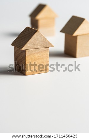 Wooden Block Toy house on a white background. Conceptual image of acquisition of housing. Copy space.