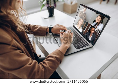 Video call. Remote work. A girl work from home. She communicate via video communication with colleagues using laptop Royalty-Free Stock Photo #1711455055