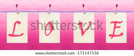 Letters hanging from a clothes line spelling Love