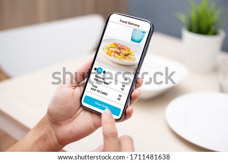 holding phone with application delivery food online Royalty-Free Stock Photo #1711481638