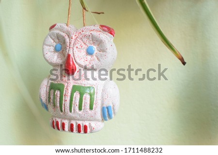 
Craft of hanging owls decoration and background a green wall