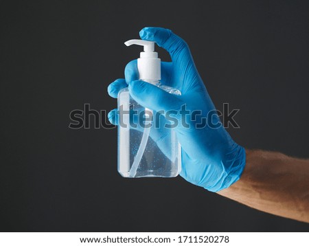 Nurse or doctor showing hand sanitizer alcohol gel with, hygiene prevention of coronavirus virus outbreak. 
