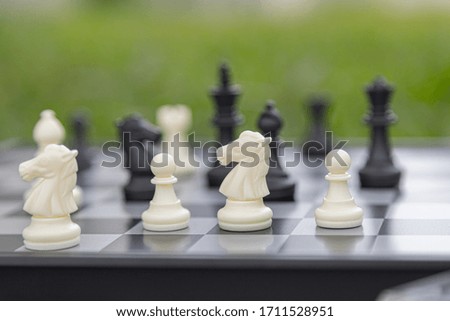 chess board game, strategy and competition in business concept with green background