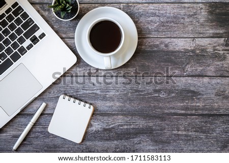 Coffee and laptops placed on a wooden table