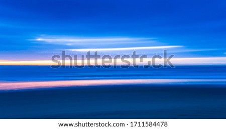 blue abstract background with lines of orange light. blurred motion effect. horizontal format