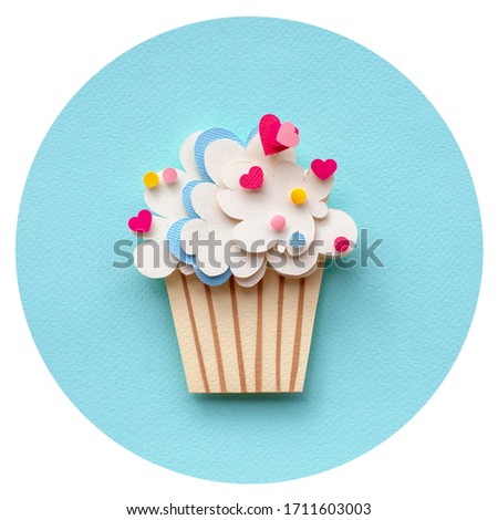 Paper cutting cupcake on blue background. Handmade art work. Colorful sprinkles or your birthday card design. In circle. 