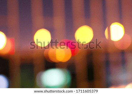 Blurred defocused picture of lights outside grilles when quarantine at residence, colorful motion circle at urban in the night,  abstract concept