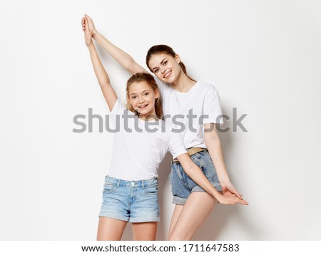 woman with little girl joined hands and smiling in camera