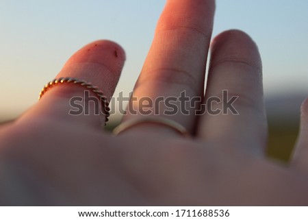 hand with two golden rings