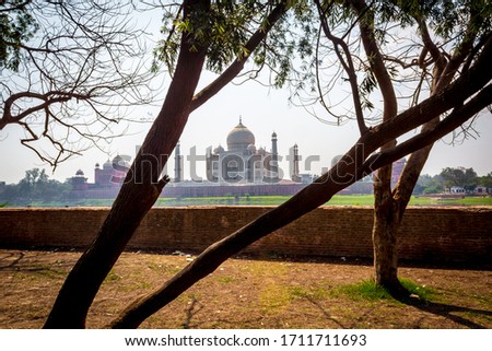 The Taj Mahal in Agra city. It is a white marble mausoleum on the banks of the Yamuna river in Uttar Pradesh India. Taj Mahal with two Mosques from Mehtab Bagh. Architecture of Taj Mahal Agra. - Image