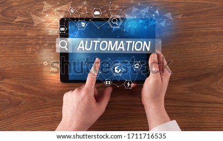Close-up of a tablet searching AUTOMATION inscription, hi-tech computing concept