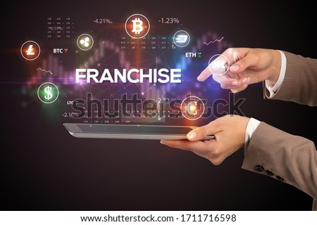 Close-up of a touchscreen with FRANCHISE inscription, business opportunity concept