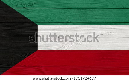 Kuwait flag on a wooden texture. Wood texture, planks Wooden texture background flag. Flag painted with paints on wood