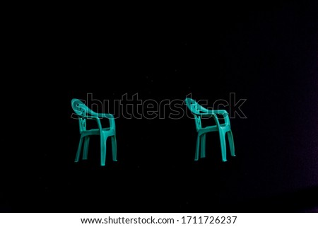 two green chair on black background.social distancing chair