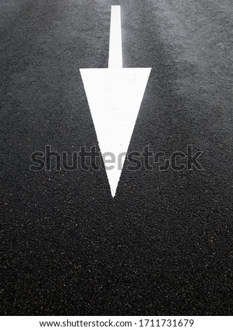 White arrow on the road. Road marking. 