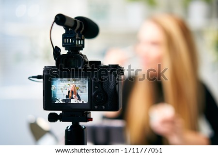 Display of camera recording video blog for blonde beauty blogger woman with make-up at home studio. Influencer vlogger girl live streaming cosmetics masterclass. Online learning and marketing concept. Royalty-Free Stock Photo #1711777051