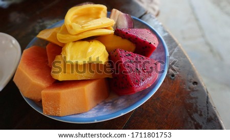 papaya mango jackfruit star apple dragon fruit on a plate in Can Tho, Mekong Delta, Vietnam, January