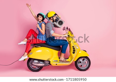 Full length profile side photo crazy cool rock stars two people motorcyclist traveling singers rider drivers ride motor bike man hold boom box woman sing mic isolated pink color background